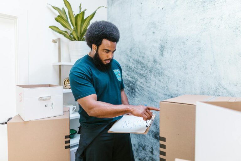 Man in Blue Crew Neck T-shirt Holding White Printer Paper